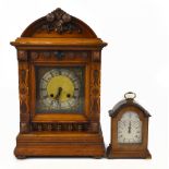 A late 19th century walnut mantel clock with carved decoration surrounding the brass base with