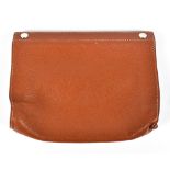 HERMÈS; a soft brown pebbled leather make up bag with pop stud closure to top and metallic strip,