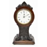 A late 19th century French mahogany mantel clock with carved floral detail, the circular dial set