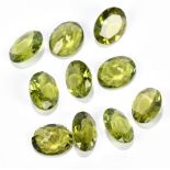 PERIDOT; ten faceted oval cut stones 10 x 8mm.