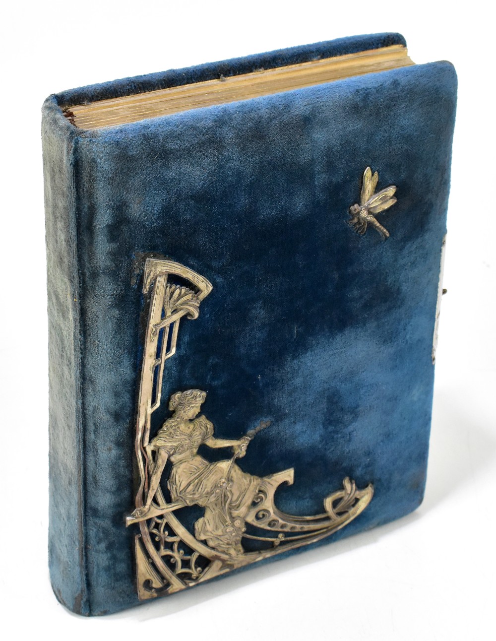 An early 20th century photograph album of rectangular form with applied silvered panel depicting