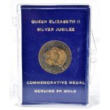 An Elizabeth II Silver Jubilee commemorative 9ct gold medallion in encapsulated case and with