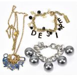 DOLCE & GABBANA; a gold tone chain link charm bracelet with black beads, black lettering charms