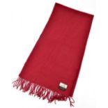 HERMÈS; a 100% cashmere burgundy red long woven scarf with fringed ends with Hermès stitched tag