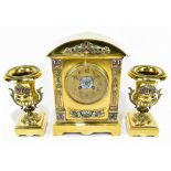 A 19th century French brass and enamelled three piece clock garniture, the clock with arched top