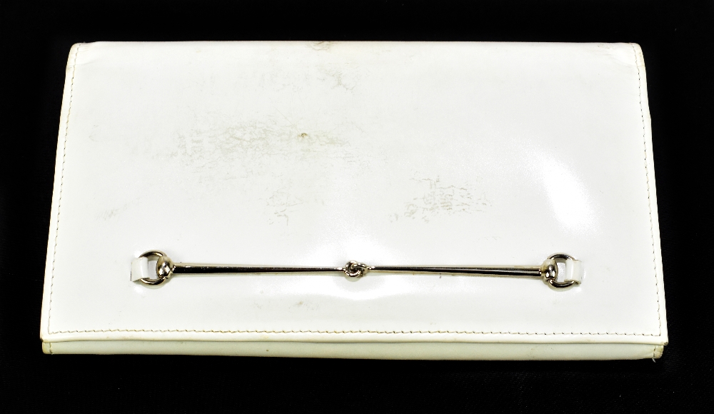 GUCCI; a white patent leather long coin and card wallet with a silver tone snaffle to front and