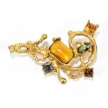 CHRISTIAN LACROIX; a vintage signed gold tone brooch with crystals and gold cabochon and stamped '