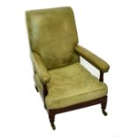 An early 19th century mahogany framed and green leather upholstered library chair, terminating on