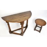 A 17th century style carved oak credence type table, height 71cm, width 97cm, depth 43cm, with a