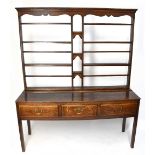 An 18th century oak dresser with open plate rack back, with an arrangement of six shelves and