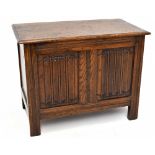 A 1920s linenfold carved oak coffer of small proportions, with hinged top on stile feet, height