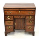 An early 19th century mahogany kneehole desk, with brush slide above one long drawer and an