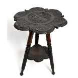 An Anglo-Indian carved hardwood occasional table, the top decorated with a deity and animals on