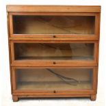 A Globe Wernicke style light oak three section bookcase on block feet, height 100cm, width 86cm,