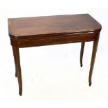 An early 19th century inlaid mahogany fold over tea table, on tapered legs, height 74cm, width 91cm,
