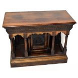 A 17th century style carved oak credence type table, with six turned column supports around a