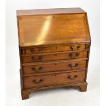 An Edwardian mahogany bureau, with fall front enclosing a fitted interior above four graduated