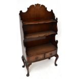 A George III style mahogany bowfronted waterfall bookcase, with two serpentine shelves and two