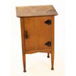 An Art Nouveau golden oak bedside cupboard, with single door, on tapered legs, height 76cm, width