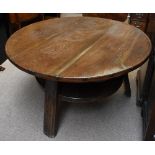 An 18th century German oak tavern table with circular plank top above dished undertier and three