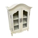 A small white painted, almost miniature, glazed armoire in the French taste, height 86cm.