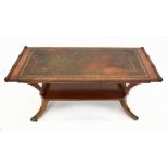 A reproduction mahogany two tier coffee table with leather inset top, height 48cm, length 104cm, and
