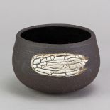 TAMSYN TREVORROW (born 1975); a grogged stoneware black bowl, impressed TT mark, diameter 13.5cm.