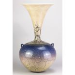 DAVID ROBERTS (born 1947); a tall raku lugged bottle covered in blue and white crackle glaze,