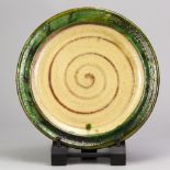 DOUG FITCH (born 1964); a slipware plate with green rim, impressed DF mark, diameter 29cm. (D)