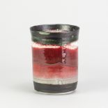 EDDIE CURTIS (born 1953); a porcelain cylindrical vessel partially covered in copper red glaze