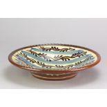 PAUL YOUNG (born 1961); a slipware dish with pie crust rim and iron and cobalt decoration,