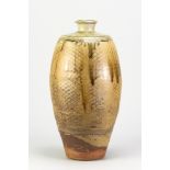PHIL ROGERS (1951-2020); a tall stoneware bottle covered in green ash glaze with incised decoration,