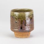 MURATA GEN (1904-1988); a stoneware yunomi, partially covered in iron glaze with running green ash