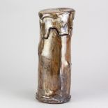 WAYNE CLARK; a tall wood fired stoneware cylindrical vessel with interlocking cover partially