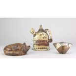 A raku teapot, earthenware vessel and stoneware sculpture of a cat by different makers, various