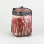 EDDIE CURTIS (born 1953); a stoneware square jar and cover partially covered in copper red glaze