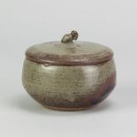 NORAH BRADEN (1901-2001); a stoneware box and cover with owl finial covered in grey/green and kaki