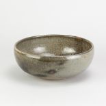NORAH BRADEN (1901-2001); a large stoneware bowl covered in grey/green and tenmoku breaking to
