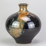 PETER SPARREY (born 1967); a large stoneware globular vase covered in tenmoku breaking to kaki and