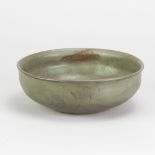 NORAH BRADEN (1901-2001); a stoneware bowl covered in dark green ash glaze with faint cobalt