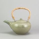 BERNARD LEACH (1887-1979) for Leach Pottery; a stoneware teapot with cane handle covered in