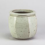 DAVID LLOYD JONES (1928-1994); a stoneware cut sided jar covered in pale grey glaze with iron spots,