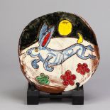 BEN FOSKER (born 1960); a slip decorated earthenware plate depicting a hare, incised B marks,