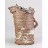 PETER SMITH (born 1941); a grogged stoneware jug form, partially slip decorated on the exterior
