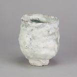ASHLEY HOWARD (born 1963); a stoneware vessel covered in pitted white glaze with copper green