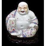 A large Chinese Famille Rose figure of Hotei modelled seated holding beads in right hand,