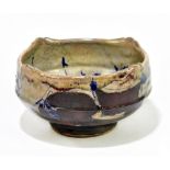 A Far Eastern saltglazed stoneware bowl, decorated in shades of blue and brown, diameter 15cm.