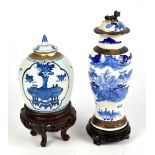 A Chinese blue and white crackle glaze vase and cover, decorated with a landscape, height 27cm, on a