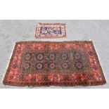 An Eastern bokhara style rug with elephant foot decoration to the centre and floral detail to the