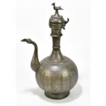 A Persian metal water pourer and cover, the cover with bird finial, the main body chased with